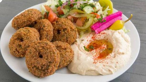 Vegan Falafel Plate · Fried fava beans and garbanzo with garlic, onions, herbs, and spices. Served with salad and vegetables tahini sauce and pita bread.