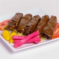 Grape Leaves · Hand rolled grape leaves stuffed with rice, tomatoes, onions, and parsley in lemon juice and...
