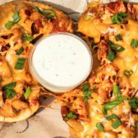 Buffalo Chicken Potato Skins · Crispy potato skins, stuffed with tender chicken breast meat tossed in our buffalo sauce, to...