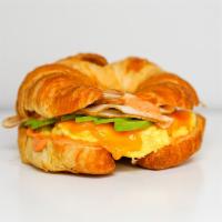 Smoked Turkey, Egg, And Avocado Croissant Sandwich · 2 scrambled eggs, melted Cheddar cheese, smoked turkey, avocado, and Sriracha aioli  on a wa...