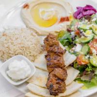 Beef Kabob Plate · Grilled Beef Kabob with a side of Rice, Hummus, Greek Salad & Pita Bread.
