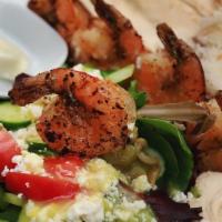 Shrimp Kabob Plate · Shrimp with a side of Rice, Hummus, Greek Salad & Pita Bread