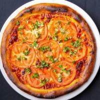 Margherita Pizza · Sliced tomato, fresh mozzarella and basil leaves with Nuno’s marinara sauce.