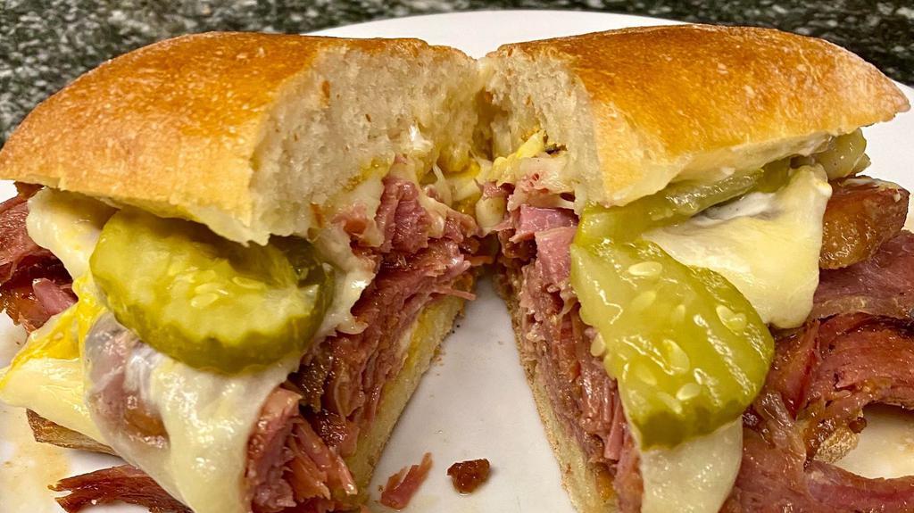 Ny Pastrami Sandwich  · Melted Swiss cheese with pastrami, sauerkraut, pickles, Mayo , mustard.