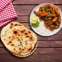 Chicken South Side & Naan Bread · South Indian specialty chunks of chicken breast marinated with Indian spices, sauteed with o...