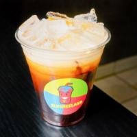Thai Ice Tea · Thai tea brewed in house poured over ice; sweetened with cane sugar and honey, topped with h...