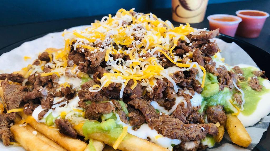 Carne Asada Fries · Fries cooked crispy , topped off with melted cheese, guacamole, sour cream, & Carne Asada!