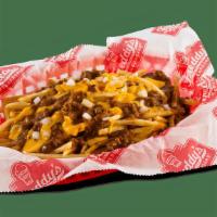 Chili Cheese Fries · Freddy's Shoestring Fries topped with chili, jalapeño cheese sauce & diced onions.