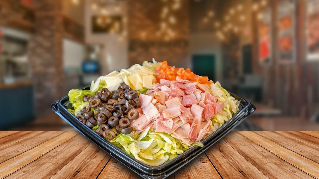Cap'S Chopped · Fresh chopped lettuce, tomatoes, provolone cheese, salami, capacolla, prosciuttini, black olives, and red wine vinaigrette. Serves 6-8.