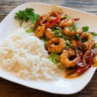 Pan Fried Prawns · Jumbo prawns sauteed in a buttery sauce with bell peppers and onions. Served on a bed of whi...