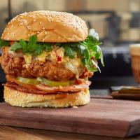 Beach City Fried Chicken Sandwich · House brined Mary's chicken, applewood bacon, pepper jack, spicy aioli, tangy slaw, tomato, ...