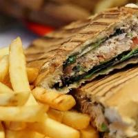 Tuna Panini · Albacore, peppers, onions dressed in mayo and spices topped with greens and tomato