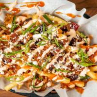 Rodeo Fries · Pork belly burnt ends, BBQ sauce, feta, scallions, spicy-sour-cream.