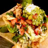Guacamole Taco · Large corn hand-made tortilla, guacamole, cilantro, tomato, onions, lettuce, mozzarella chee...
