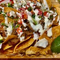 Macho Nachos · Cut and fried to order tortilla chips topped with cheddar (nacho cheese), beans, cilantro, t...