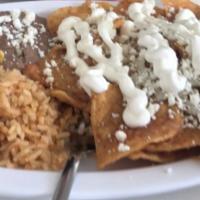 Red Chilaquiles · Fried tortilla chips on the spicy special sauce, mozzarella cheese, onions, queso fresco and...