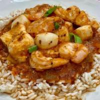Seafood Creole · Scallops, shrimp, and white fish simmered in a spicy red creole sauce on a bed of rice.