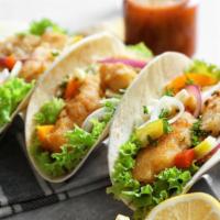 Fish Taco · Fish taco large tortilla with pico de gallo, cabbage salad, and house sauce, drizzled with c...