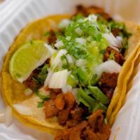 Adobada Taco · Grilled Marinated Pork
Topped with Guacamole, Chopped Onion and Cilantro
Served on Corn Tort...
