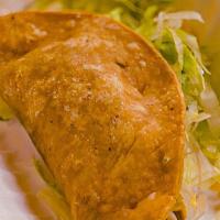 Shredded Chicken Taco · Marinated Shredded Chicken
Topped with Shredded Lettuce and Shredded Cheese
Served in a Cris...