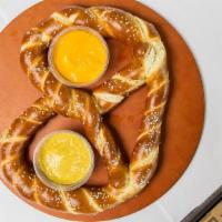 Bavarian Pretzel · A warm and salted pretzel served with housemade beer cheese sauce and spicy mustard - big en...