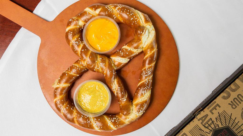 Bavarian Pretzel · A warm and salted pretzel served with housemade beer cheese sauce and spicy mustard - big enough to share.