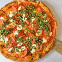 Margherita · Classic red sauce, central vally tomatoes, fresh mozzarella topped with fresh basil and dres...
