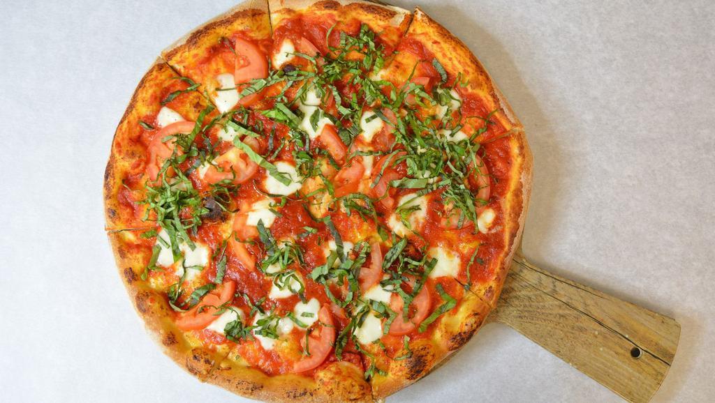 Margherita · Classic red sauce, central vally tomatoes, fresh mozzarella topped with fresh basil and dressed with 100% extras virgin olive oil.