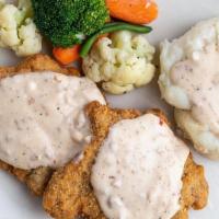 Country Fried Steak · Tender, flavorful steaks dipped in thick batter and fried to a crispy golden brown and smoth...