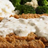 Country-Fried Steak · Tender, flavorful steak dipped in thick batter and fried to a crispy golden brown and smothe...