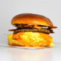 Brioche, Sausage, Bacon, Egg & Cheddar · 2 scrambled eggs, melted Cheddar cheese, smoked bacon, breakfast sausage, grilled onions, an...