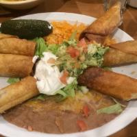 Flautas · Chicken or beef served with rice and beans.
