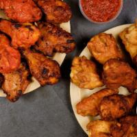 Man Cave Wings ™ · Your choice of Smokin' Dry Rub, Spicy Buffalo, Honey BBQ, or any combination of them.