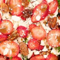 Signature Strawberry Fields Salad · Fresh field greens, topped with feta, candied pecans, and freshly sliced, organic strawberri...