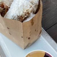 Pb&J Beignets · Deep fried donut pieces tossed in powdered sugar. Served with peanut
butter sauce (peanut bu...