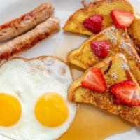 French Toast Special · Three half slices of French toast served with strawberries and bananas on top, two eggs and ...