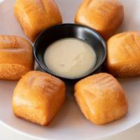 Golden Fried Buns (6 Pieces) · One oz cute crispy puffy bun served with condensed milk.