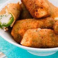 Jalapeno Poppers · Deep Fried breaded Jalapeno poppers stuffed with cream cheese. Served with Ranch dipping sau...