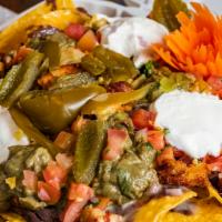 Super Nachos​ · House-made chips, black beans, guacamole, sour cream, Jack cheese, pico, pickled jalapeños, ...