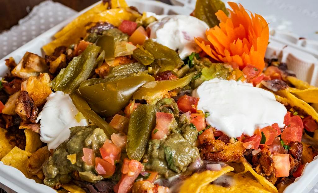 Super Nachos​ · House-made chips, black beans, guacamole, sour cream, Jack cheese, pico, pickled jalapeños, choice of meat.