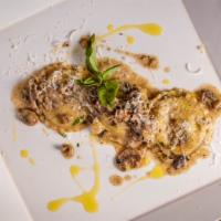 Mushroom Ravioli · Filled with ricotta cheese in a mushroom truffle pesto cream sauce with basil and parmesan.