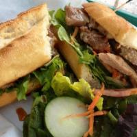 #35 Banh Mi · Choice of grilled pork or chicken in a french baguette with mayo, pate, cucumber, carrot pic...