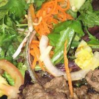 #23 Beef Salad · Rib-eye beef marinated with lemongrass, grilled to perfection, served with a mixed green sal...