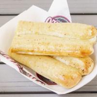 2 Breadsticks · Fresh baked, light and airy breadsticks, brushed with garlic butter.