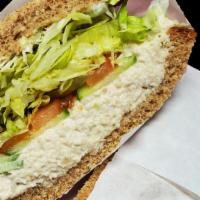 Chicken Salad · Chicken salad sandwich on sliced squaw bread with tomatoes, lettuce, sprouts, cucumbers, and...