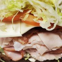 Billy Club · Toasted club sandwich with ham, turkey, bacon, American cheese, tomatoes, lettuce.