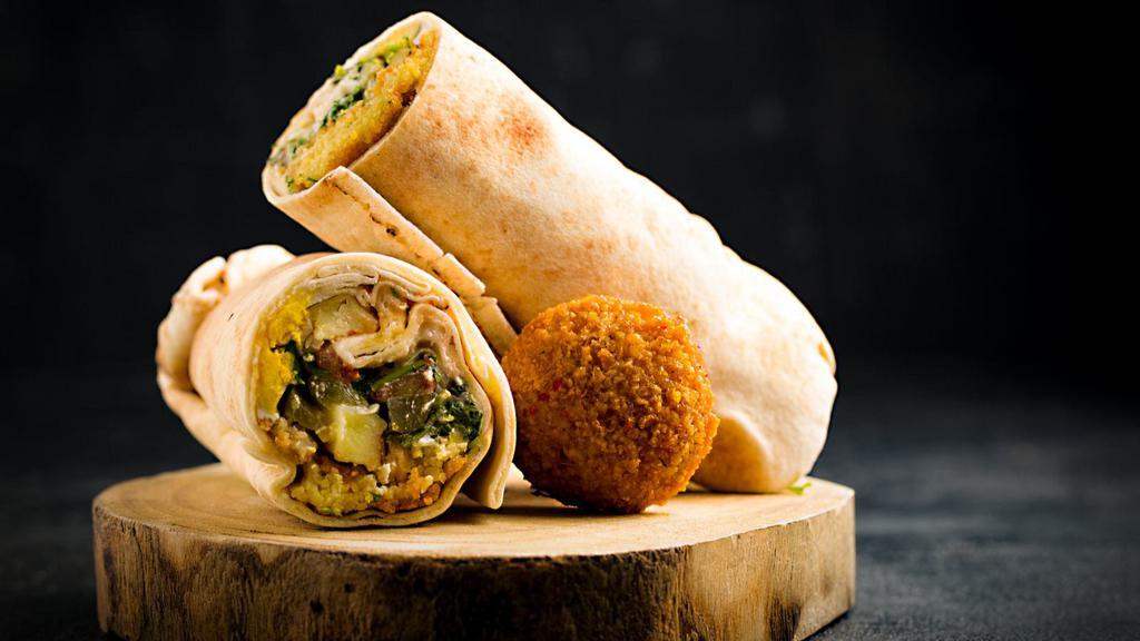 Chicken And Falafel Wrap · Fresh crispy falafels and chicken with hummus, lettuce, onions, tomatoes, salata, tzatziki sauce all wrapped up in a pita bread.