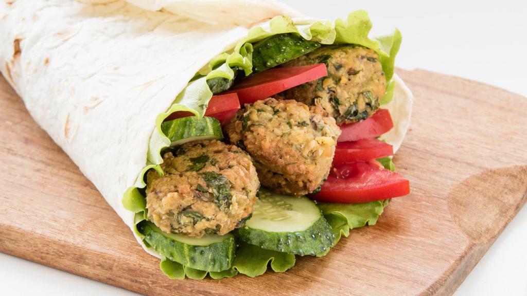 Gyro And Falafel Wrap · Fresh crispy falafels and juicy gyro meat with hummus, lettuce, onions, tomatoes, salata, tzatziki sauce all wrapped up in a pita bread.