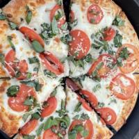 Margherita · Lightly seasoned olive oil, tomatoes, mozzarella topped with fresh basil and Asiago cheese.