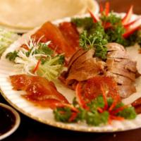 Traditional Roasted Peking Duck · With 10 pcs  house pancakes, shredded scallions and cucumbers.